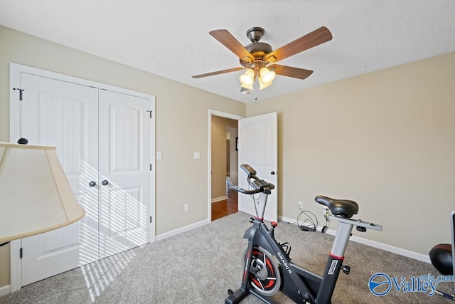 workout room featuring ceiling fan and baseboards