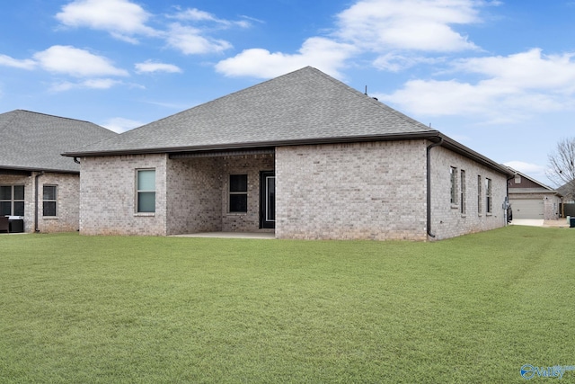 back of property with a yard and a patio