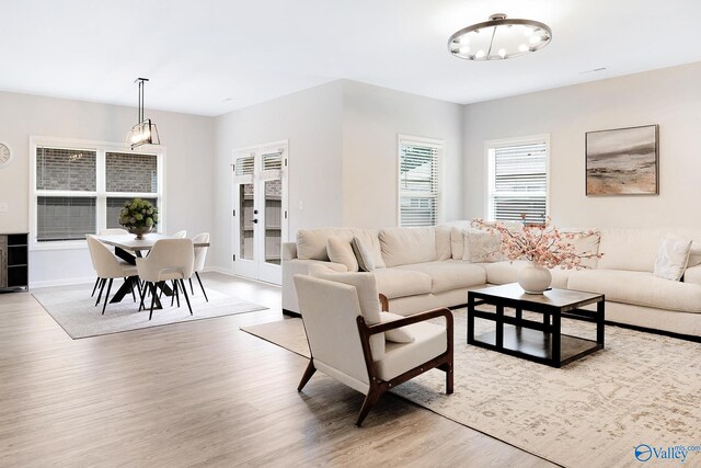 103 Barlow Way, Owens Cross Roads, AL 35763 - living area featuring light wood-style floors and a chandelier