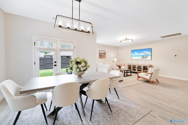 103 Barlow Way, Owens Cross Roads, AL 35763 - dining space featuring light wood-style floors and a chandelier
