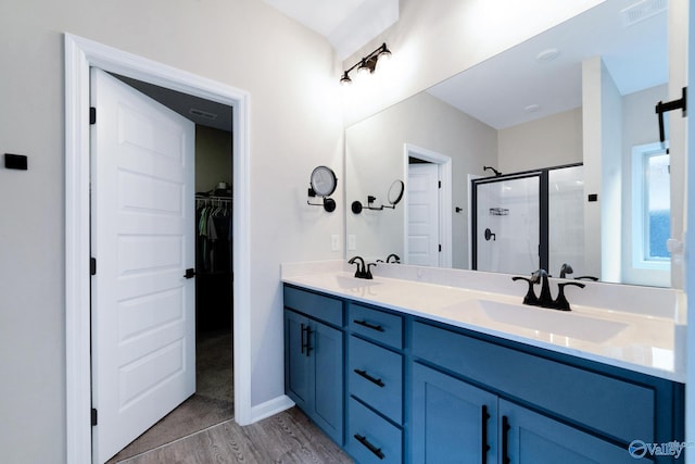 103 Barlow Way, Owens Cross Roads, AL 35763 - full bath with a shower stall, wood finished floors, double vanity, and a spacious closet