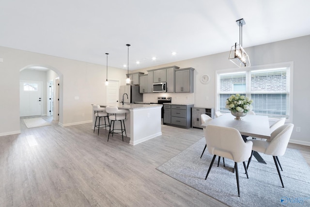 103 Barlow Way, Owens Cross Roads, AL 35763 - dining space with plenty of natural light, arched walkways, light wood-style flooring, and recessed lighting