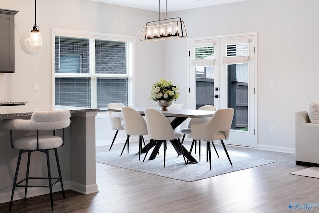 103 Barlow Way, Owens Cross Roads, AL 35763 - dining area featuring wood finished floors and a chandelier