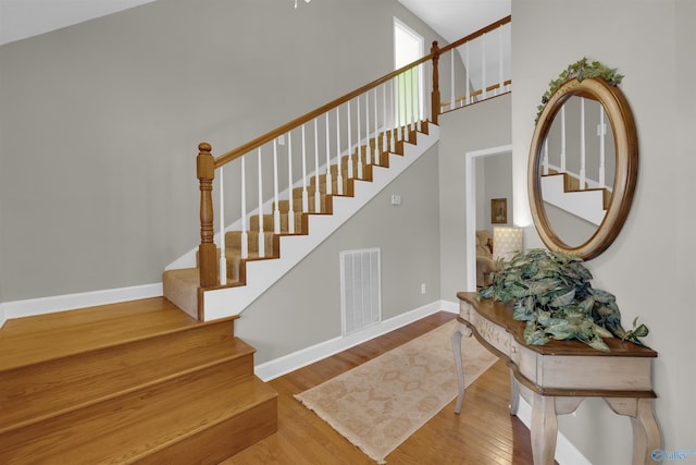 stairs with hardwood / wood-style floors