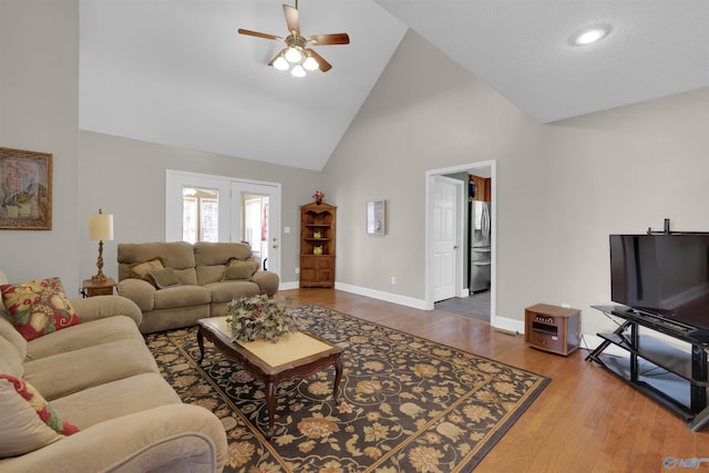 living room with high vaulted ceiling, hardwood / wood-style flooring, and ceiling fan