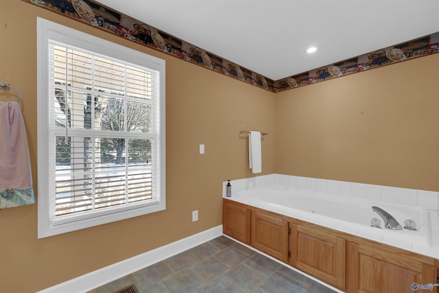 bathroom with a tub to relax in and a wealth of natural light