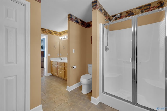 bathroom with vanity, toilet, tile patterned flooring, and an enclosed shower