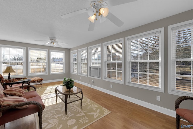 sunroom / solarium with ceiling fan and cooling unit