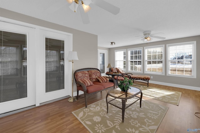 sunroom with ceiling fan and a healthy amount of sunlight