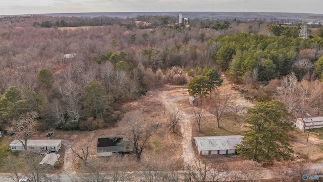 drone / aerial view featuring a wooded view
