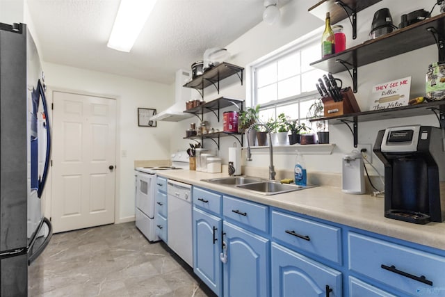 kitchen featuring open shelves, wall chimney exhaust hood, blue cabinets, and white appliances