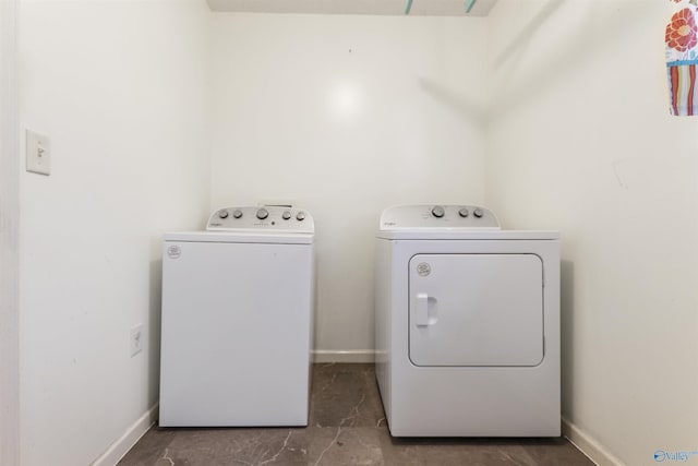 laundry area featuring laundry area, baseboards, and washer and clothes dryer