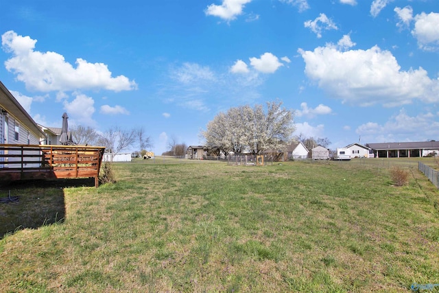 view of yard with fence and a wooden deck