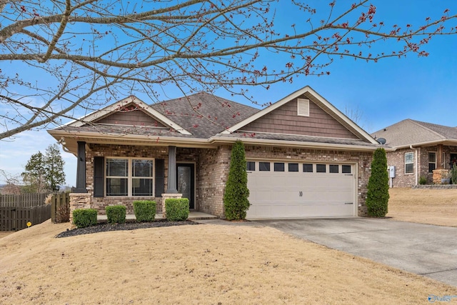 view of front of property with roof with shingles, brick siding, fence, a garage, and driveway