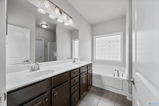 bathroom with a garden tub, double vanity, a sink, a shower stall, and tile patterned flooring