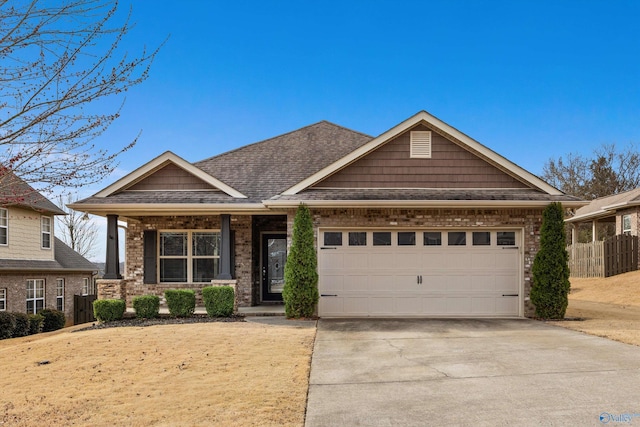 craftsman-style home with a garage, brick siding, fence, concrete driveway, and roof with shingles