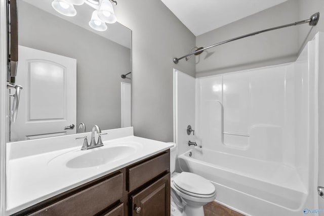 full bath featuring vanity, bathtub / shower combination, and toilet