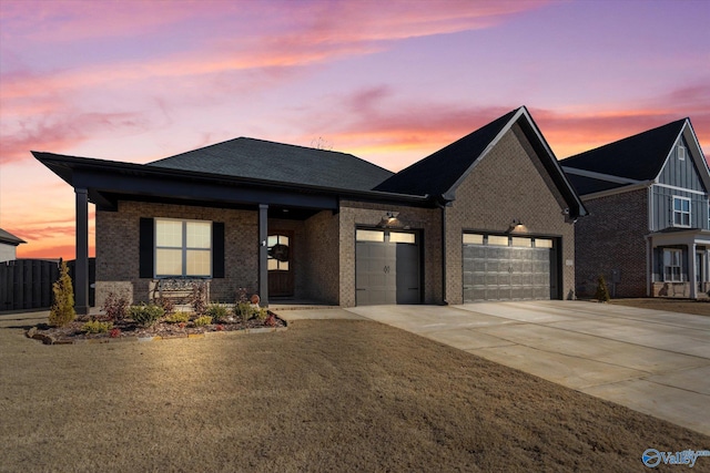 view of front facade with a garage and a lawn