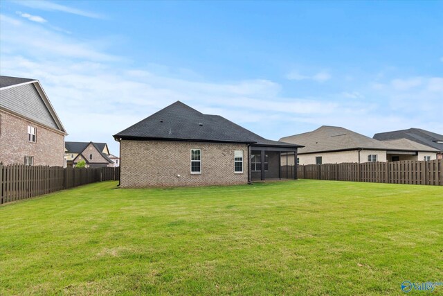 127 Parkland Hill Trce, Madison, AL 35756 - back of property with brick siding, a fenced backyard, a yard, and a sunroom