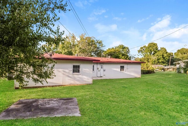 rear view of property with a patio area and a yard