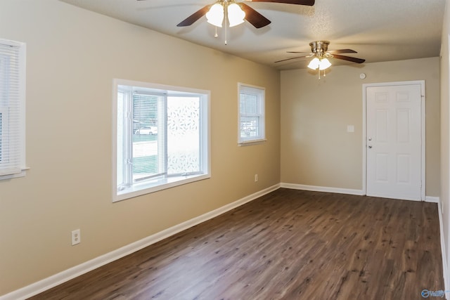 spare room with ceiling fan, a textured ceiling, and dark hardwood / wood-style flooring