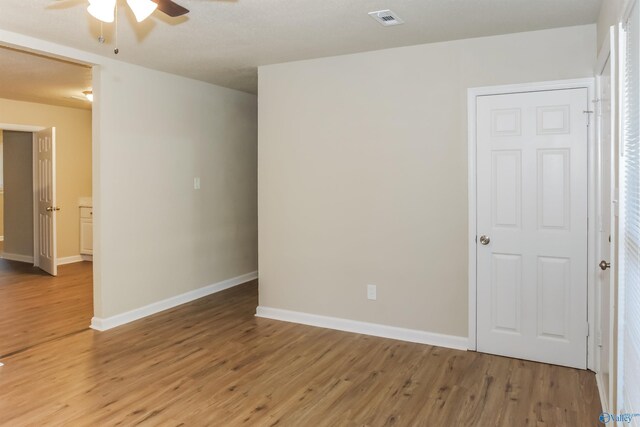 spare room with wood-type flooring and ceiling fan