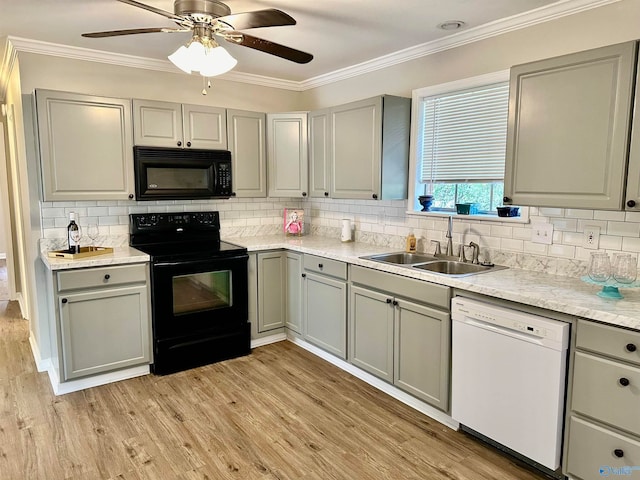 kitchen with black appliances, ceiling fan, light hardwood / wood-style flooring, ornamental molding, and sink