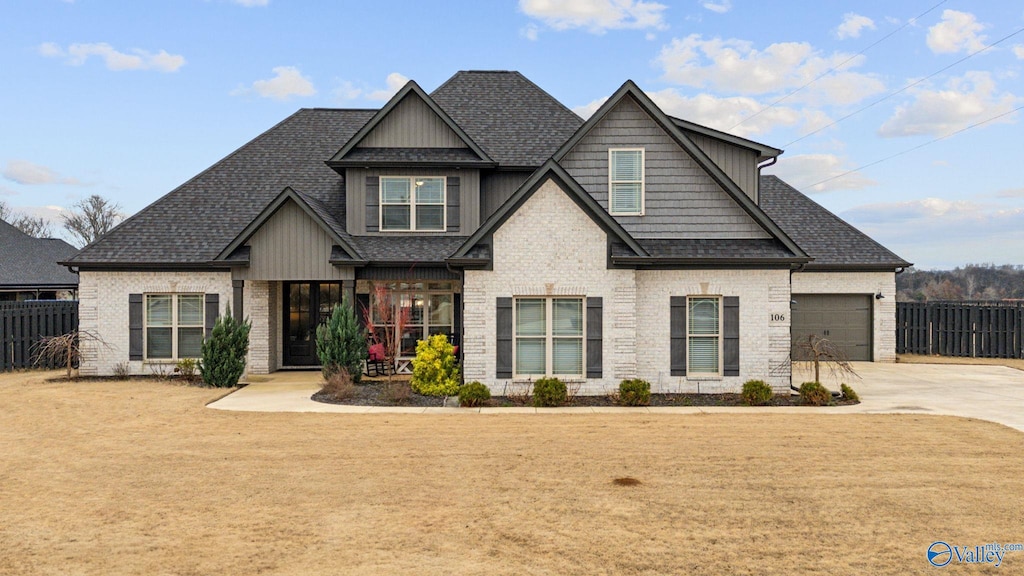 craftsman house featuring a front yard and a garage