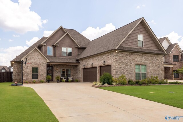 craftsman inspired home featuring a garage and a front yard