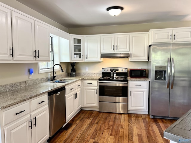 kitchen featuring a sink, white cabinets, under cabinet range hood, and stainless steel appliances