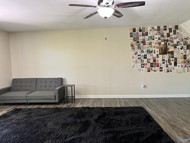 living area featuring wood finished floors, ceiling fan, and baseboards