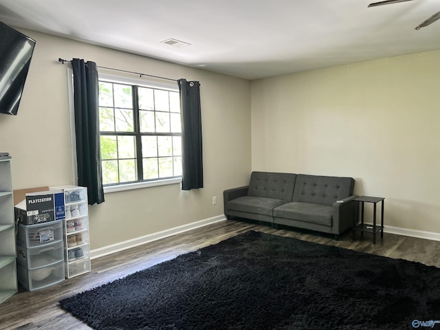 sitting room featuring visible vents, baseboards, and wood finished floors