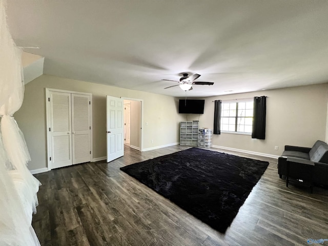 living room with baseboards, a ceiling fan, and wood finished floors
