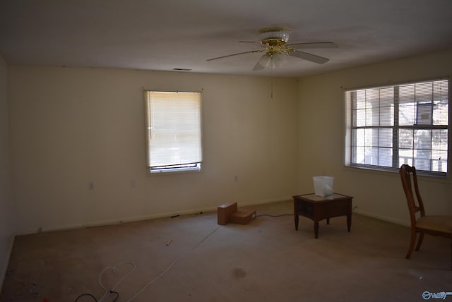 spare room with baseboards and ceiling fan