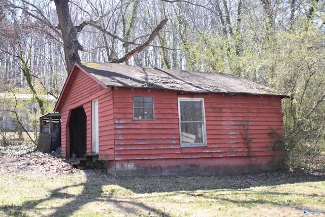 view of side of home featuring an outbuilding