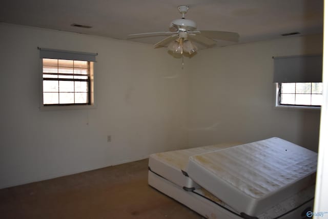 unfurnished bedroom with visible vents, baseboards, carpet, and a ceiling fan