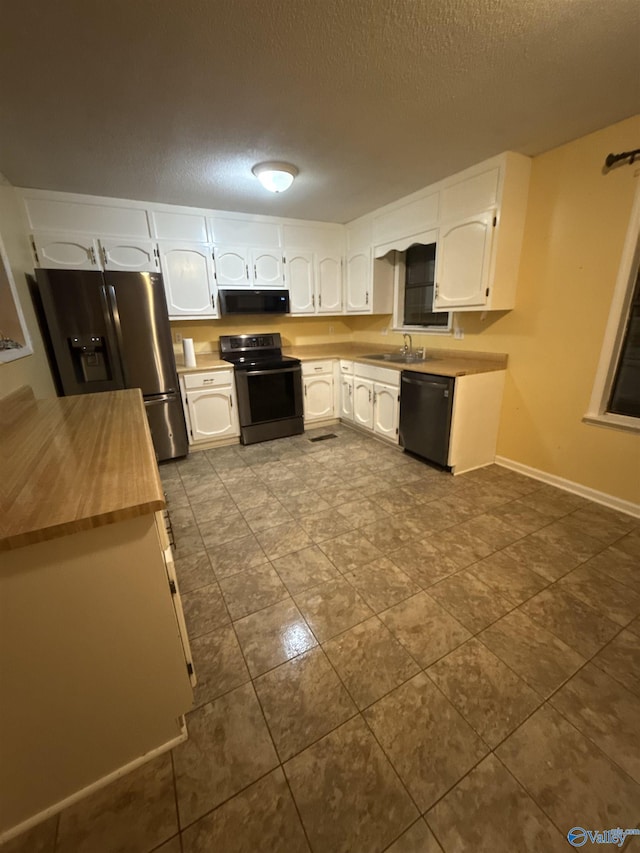 1714 Wilshire Ave SW, Decatur, AL 35603 - kitchen featuring electric range, dishwashing machine, stainless steel fridge, wood counters, and white cabinets