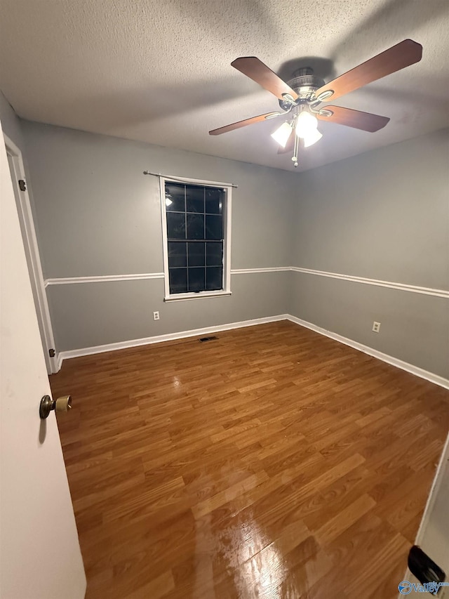 1714 Wilshire Ave SW, Decatur, AL 35603 - empty room with wood finished floors, a ceiling fan, and a textured ceiling