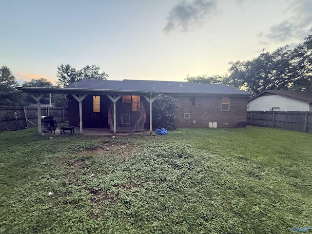 1714 Wilshire Ave SW, Decatur, AL 35603 - back of property featuring a fenced backyard, a patio area, brick siding, and crawl space