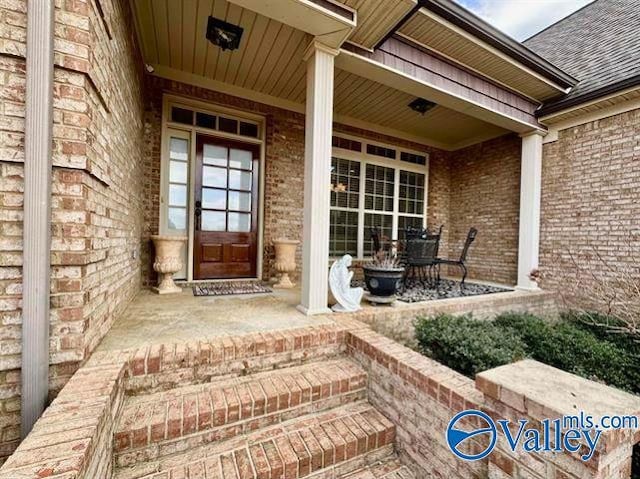 view of exterior entry featuring a porch