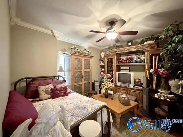 bedroom with ceiling fan and ornamental molding