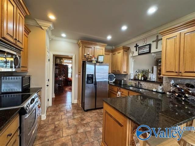 kitchen featuring dark stone counters, backsplash, sink, and stainless steel appliances