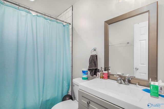 bathroom featuring vanity, a shower with shower curtain, and toilet