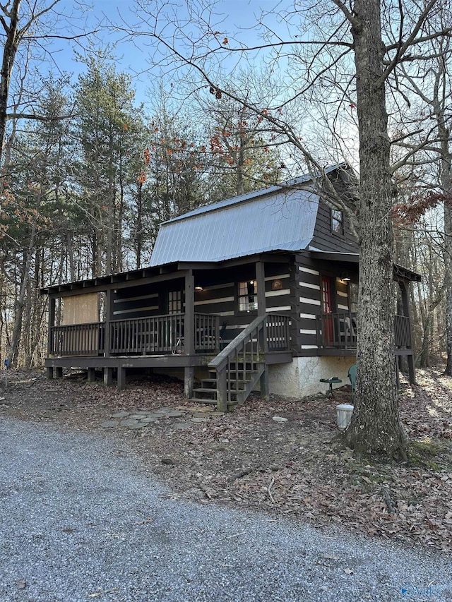 exterior space with log siding and metal roof