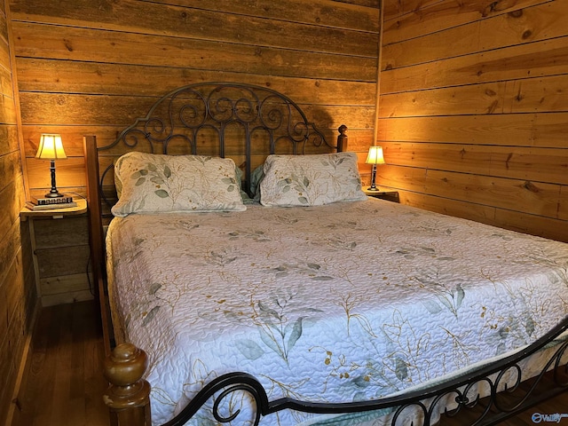 bedroom featuring wooden walls