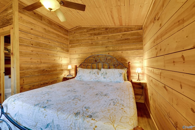 unfurnished bedroom featuring wood ceiling, ceiling fan, wood finished floors, vaulted ceiling, and wood walls