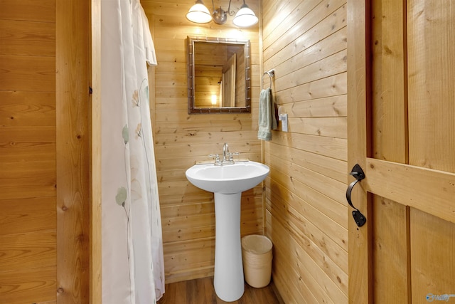 bathroom with wood walls