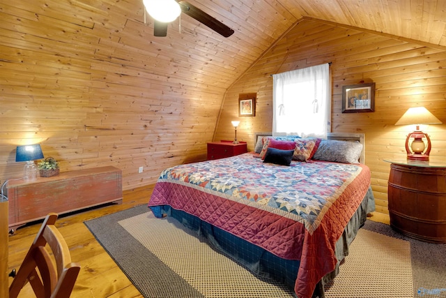 bedroom with a ceiling fan, wooden ceiling, light wood-style flooring, vaulted ceiling, and wood walls