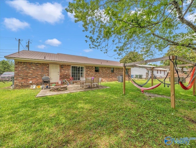812 Mitwede St SW, Hartselle, AL 35640 - rear view of house with a patio area, a playground, a lawn, brick siding, and metal roof