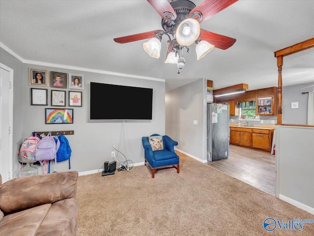 812 Mitwede St SW, Hartselle, AL 35640 - living room featuring a ceiling fan, light colored carpet, a textured ceiling, and baseboards
